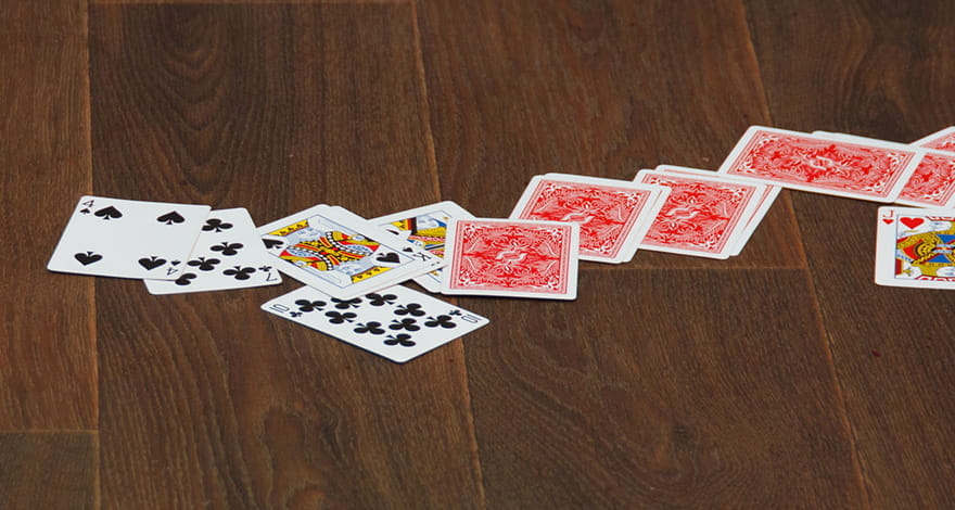 Cards Split on the Floor. A Pile of Mixed Cards and 5 Hole Cards.